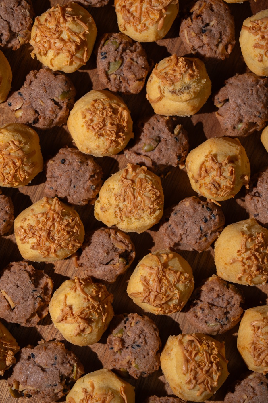 Mixed cookies arranged on a wooden surface